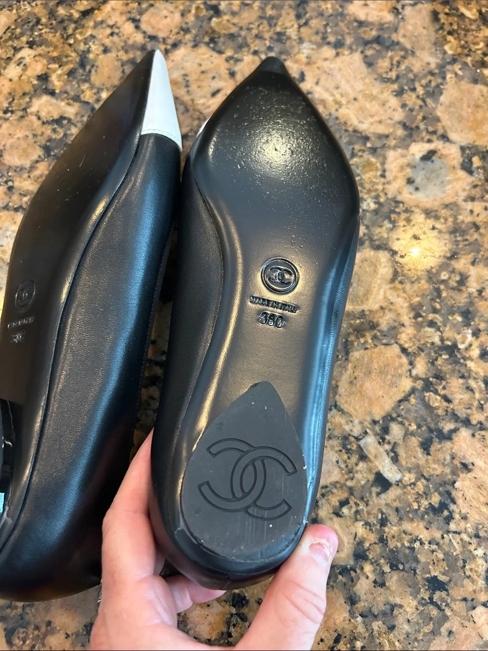 CHANEL Black Leather Flats with White Pointed Toe and CC Stitching